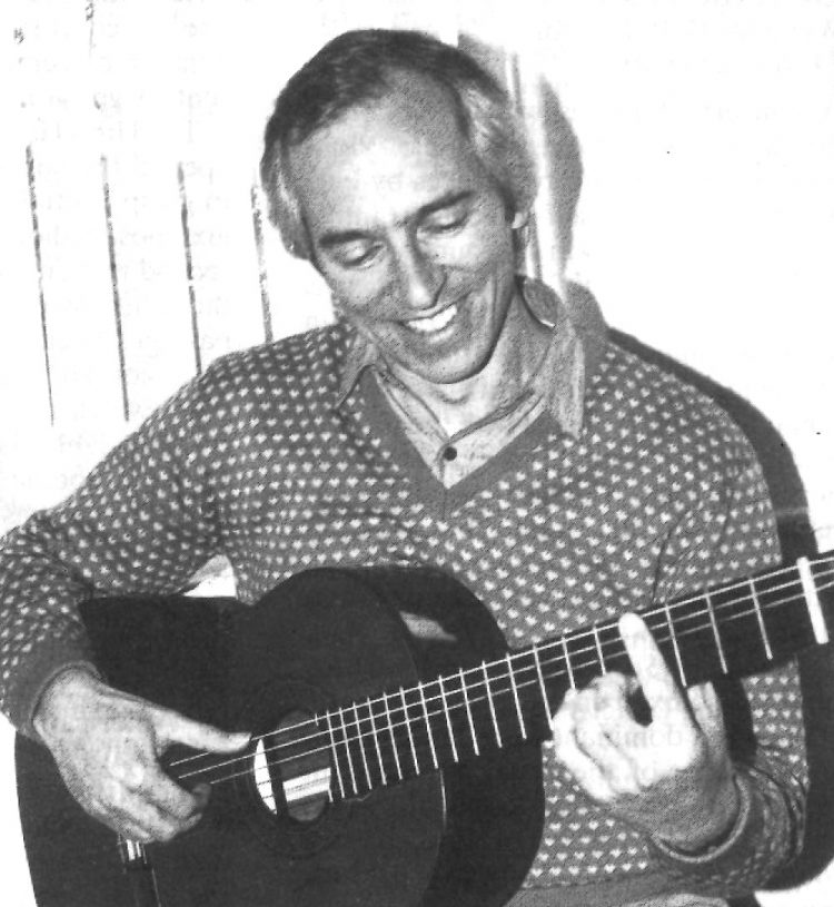 classical guitarist john williams holding guitar