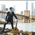 Pablo Sainz-Villegas on the river banks beneath a bridge with Classical Guitar®168网极速赛车体彩数据站